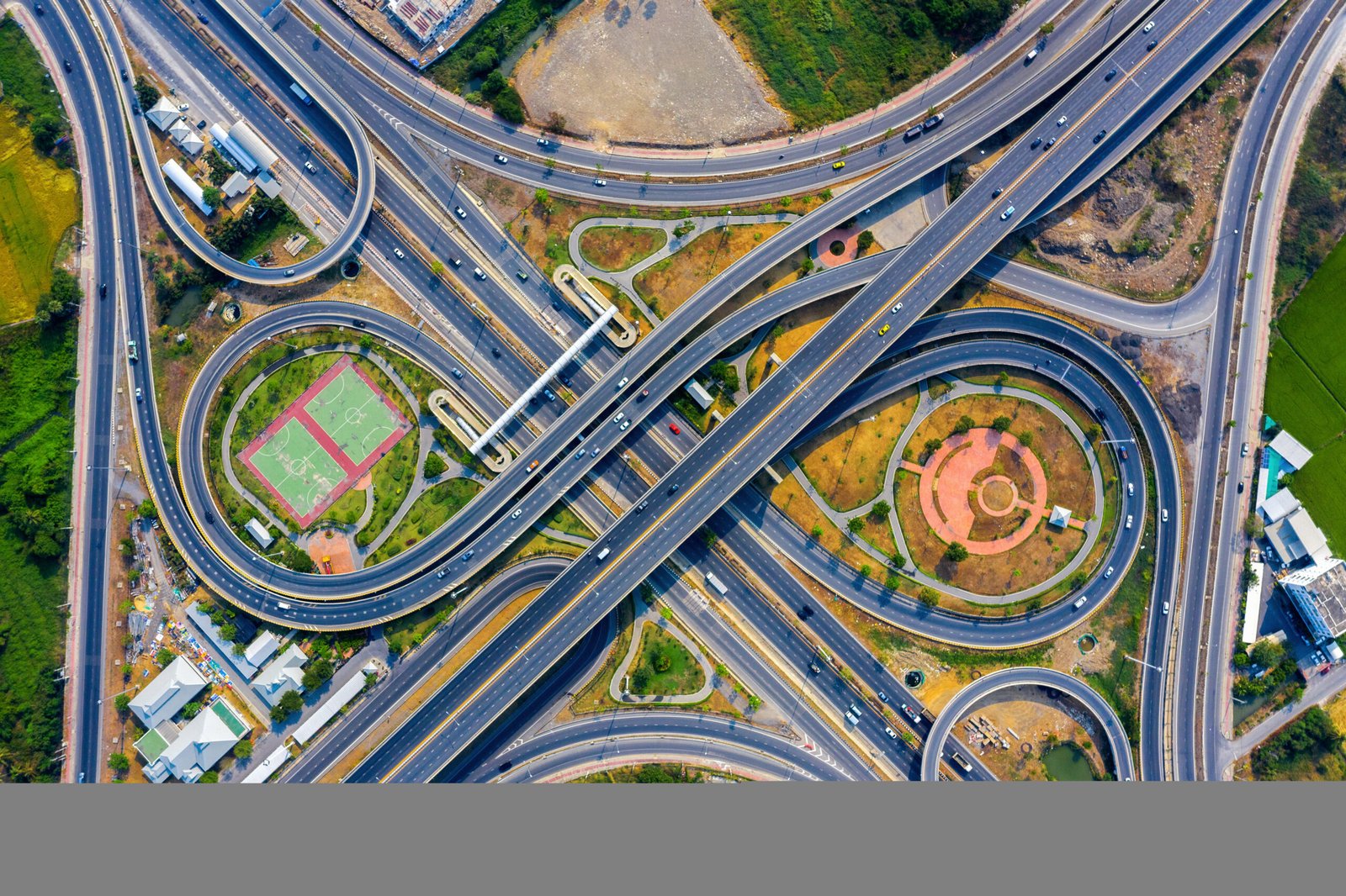 Home aerial view of traffic on massive highway intersection.