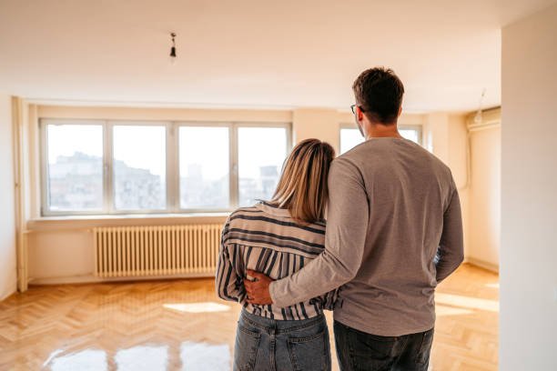 Home young loving heterosexual couple embracing in their new home.